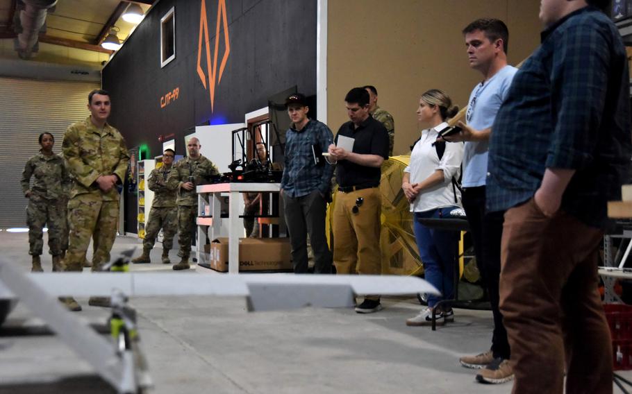 U.S. Air Force Staff Sgt. Christopher Gilbert briefs visitors on technologies being tested by Task Force 99 on May 11, 2023. Gilbert is an explosive ordnance disposal technician with the task force, a military test unit for commercial technology based out of  Al Udeid Air Base, Qatar. 