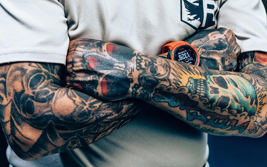 Military veteran Enrique Torres shows his tattooed arms in August 2021 at Kleber Kaserne in Kaiserslautern, Germany. A newly released Air Force regulation allows airmen neck and hand tattoos up to 1 inch long, so this artwork still would not be allowed for them.