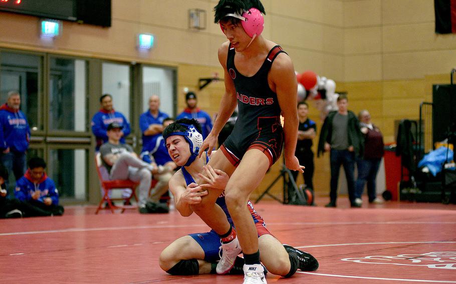 Kaiserslautern's Joshua Kim breaks out of the grip by Ramstein's Camren Carlson during the 126-pound final at a wrestling meet on Jan. 27, 2024, at Kaiserslautern High School in Kaiserslautern, Germany.