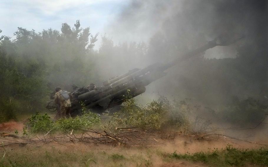 Ukrainian soldiers fire at Russian positions from a U.S.-supplied M777 howitzer in Ukraine's eastern Donetsk region Saturday, June 18, 2022. 
