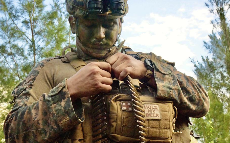 A Marine from Alpha Company, 1st Battalion, 2nd Marine Regiment out of Camp Lejeune, N.C., prepares for an exercise at the Central Training Area on Okinawa, Dec. 7, 2022.