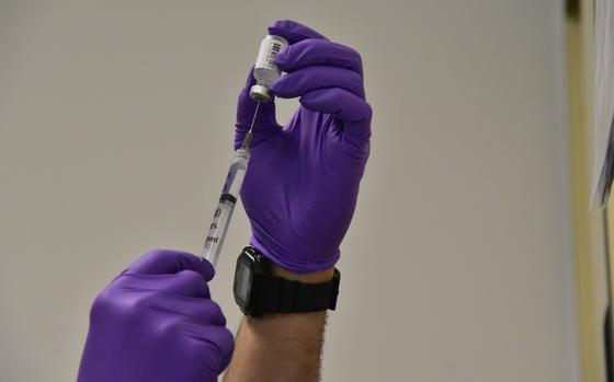 Base Alameda medical clinic personnel draw a dosage of the coronavirus (COVID-19) vaccine from a vial to administer to base medical staff in Alameda, Calif., Dec. 16, 2020. Coast Guard efforts to vaccinate its workforce, in collaboration with DoD, will be complementary to a parallel effort by states, territories, and localities, as vaccine supply allows. U.S. Coast Guard photos by Chief Petty Officer Matt Masaschi.