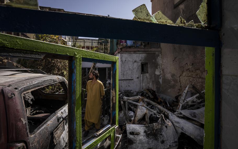 In this Sept. 13, 2021, file photo, an Afghan inspects the damage of Ahmadi family house in Kabul, Afghanistan. A U.S. drone strike killed 10 members of the family, including seven children. On Sept. 18, 2021, they demanded Washington investigate who fired the drone and punish the military personnel responsible for the strike, said Emal Ahmadi, whose 3-year-old daughter Malika was killed Aug. 29 when the U.S. hellfire missile struck his elder brother’s car.