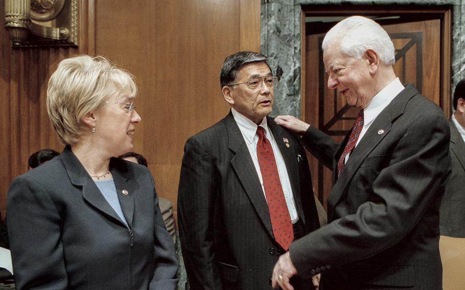 Then-Sen. Robert C. Byrd, D-W.Va., speaks with then-Transportation Secretary Norman Mineta, center, as Sen. Patty Murray, D-Wash., looks on before a hearing on  Capitol Hill in June 2002. At the time, Byrd was 84, and his duties in the Senate included being president pro tempore of the chamber.