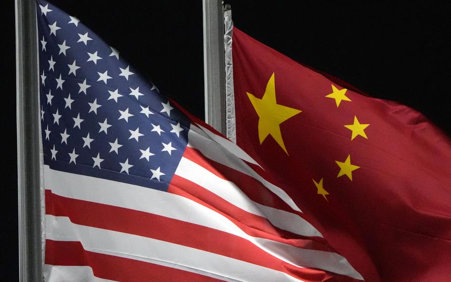 The American and Chinese flags wave next to each other