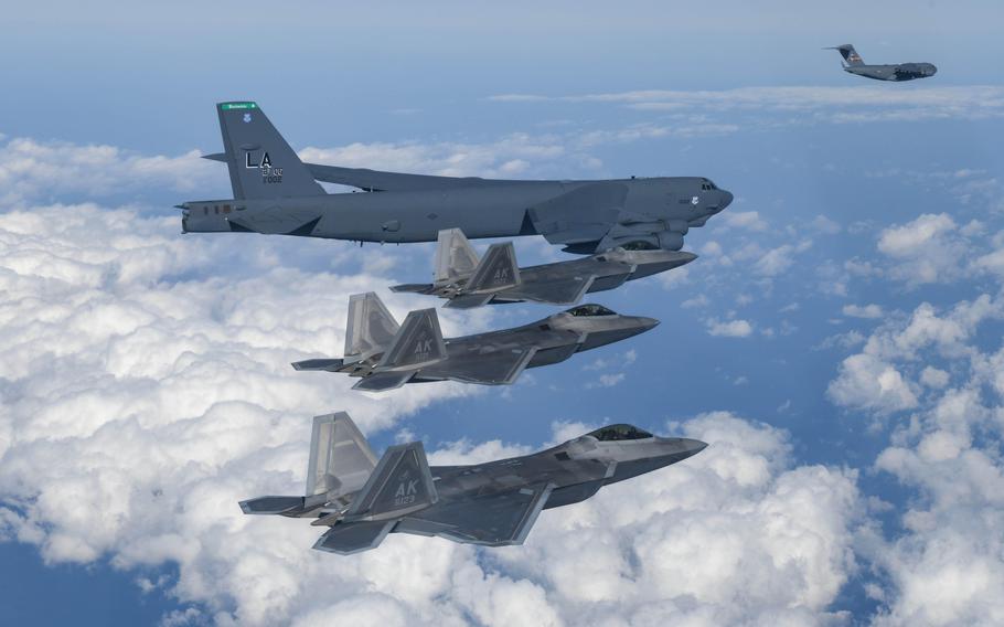 Air Force F-22 Raptors, a B-52 Stratofortress bomber and a C-17 Globemaster are pictured flying for a joint drill with South Korean aircraft over South Korea on Dec. 20, 2022. 
