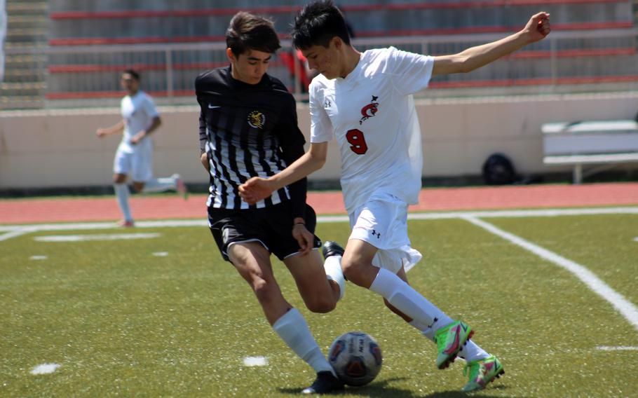 Matthew C. Perry's John Shaver and E.J. King's Christian Garcia try to play the ball during Saturday's DODEA-Japan soccer match. Shaver had the match's lone goal as the Samurai won 1-0.