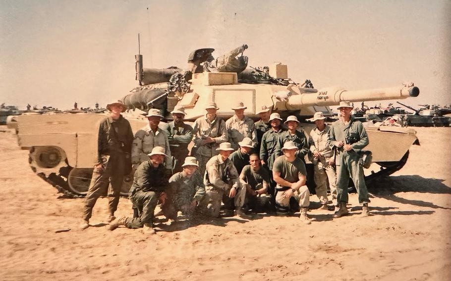Tim McLaughlin, his tank and his platoon in 2003, around the time that U.S. forces invaded Iraq. 