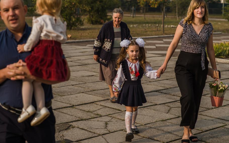 Parents and children walk to school on the first day of classes in Nove Zalissya. 