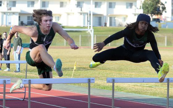 Kubasaki's Caleb Stephan and Carlos Cadet crest oveer the final hurdle in the 110-meter hurdles during Thursday's Day 2 of the two-day Okinawa track and field meet. Cadet and Stephan finished 1-2.