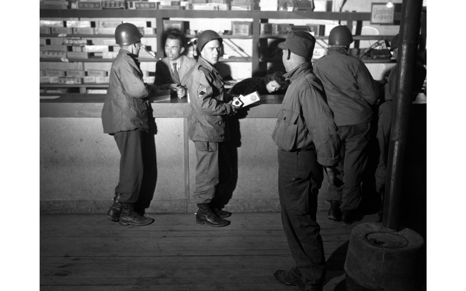A black and white photo of soldiers in a commissary.