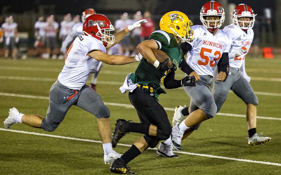 Robert D. Edgren ballcarrier Evan Moreno finds himself hemmed in by Nile C. Kinnick defenders.