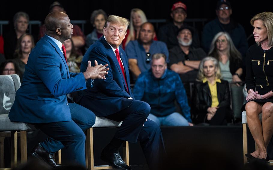 Former president Donald Trump speaks with Sen. Tim Scott (R-S.C.) and moderator Laura Ingraham during a Fox News town hall in Greenville, S.C., on Tuesday, Feb. 20, 2024. 