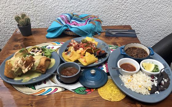 Beef chimichangas, nachos al pastor, and a barbacoa plate, from left, as served at Casa Azteca in Wiesbaden, Germany in August 2022. 