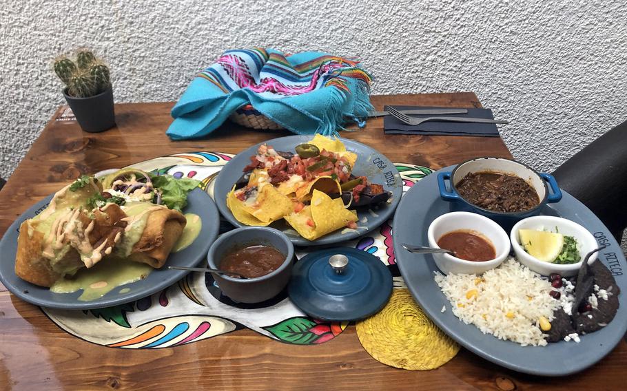 Beef chimichangas, nachos al pastor and a barbacoa plate, from left, as served at Casa Azteca in Wiesbaden, Germany, in August 2022. 