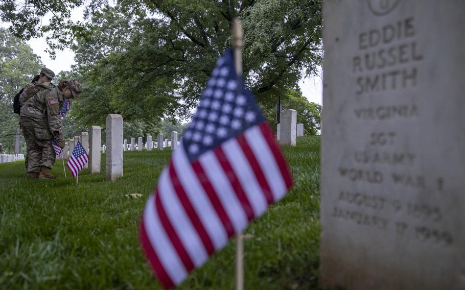 A flag in front of a headstone.