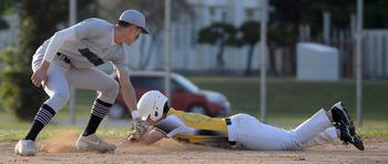 Kubasaki shortstop Jeffrey Owens is a tad late with the tag on Kadena baserunner Ayden Jennings during Monday's DODEA-Okinawa baseball game. The Panthers won 7-6 in eight innings to level the season series 4-4.