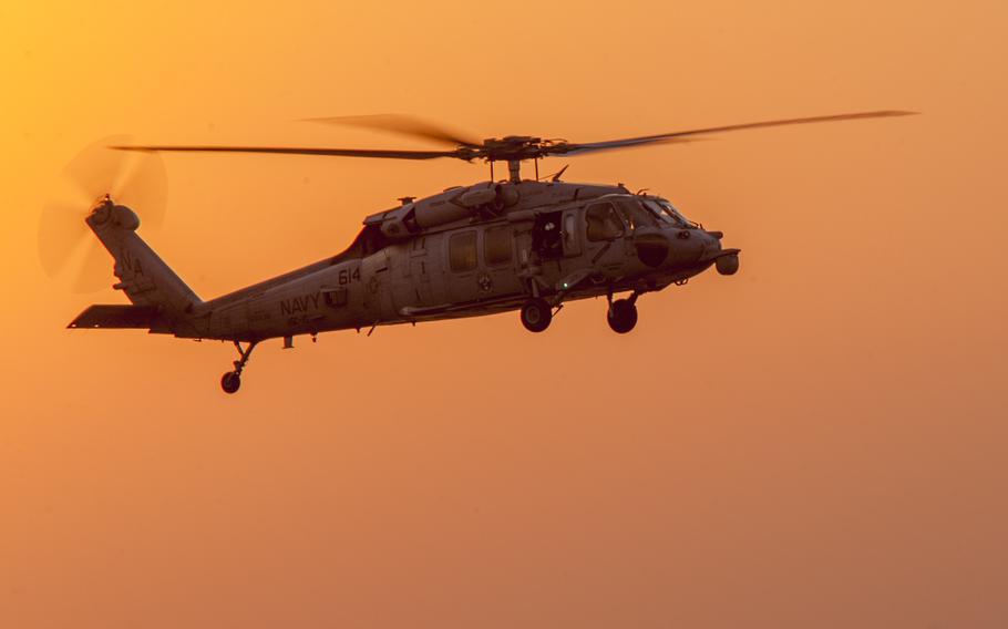 An MH-60S helicopter conducts flight operations in 2014. 