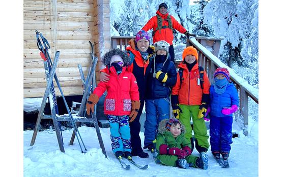 Alice Byrne, second from left in foreground, with her five children at a ski-in cabin near Fort Wainwright, Alaska. On the porch behind them is her husband and father of the children, Capt. Matthew Byrne, an Army internist at the garrison’s medical facility. 