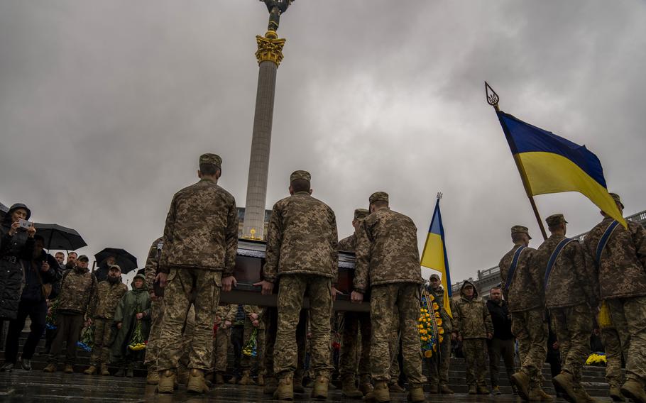 Honor guards carry the coffin of Ukrainian army paramedic Nazarii Lavrovskyi, 31, killed in the war, during his funeral ceremony at Independence square in Kyiv, Wednesday, April 24, 2024. 