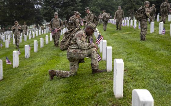 Members of the ArmyÕs 3d U.S. Infantry Regiment (also known as The Old Guard) honors AmericaÕs fallen heroes by placing American flags at gravesites for service members on Thursday, May 22, 2025, in Washington at Arlington National Cemetery. The tradition, known as ÒFlags-In,Ó has taken place annually since 1948. Every available solider in the Old Guard participates. Small American flags are placed at approximately 260,000 headstones and 7,000 niche rows within the columbarium. Each flag is inserted into the ground, exactly one boot length from the headstoneÕs base. It takes nearly 1,500 soldiers, including approximately 100 joint service members, four hours to complete Flags-In. (Eric Kayne/Stars and Stripes)