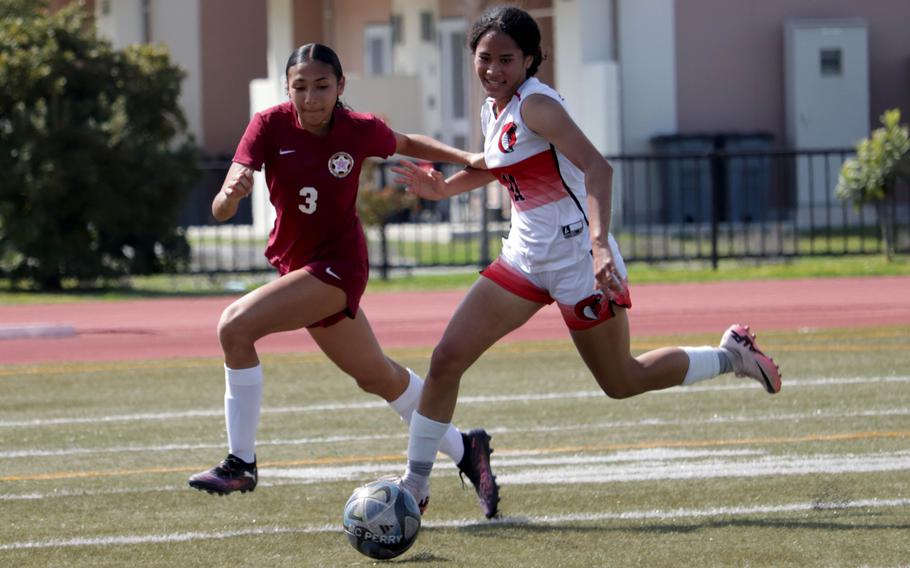 Naiya Burford and Aniah Little follow the ball.