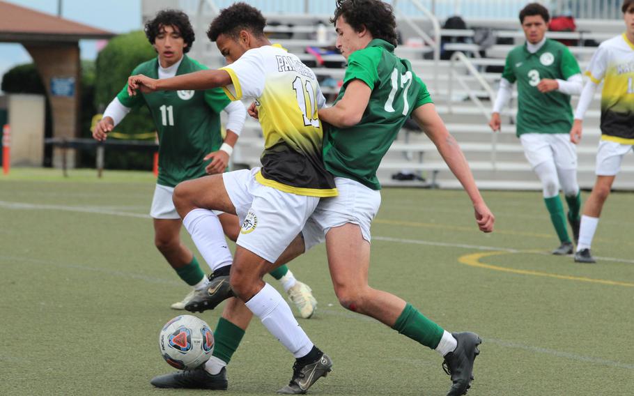 Kadena's Yoshua Whipp and Kubasaki's David Allison scuffle for the ball during Monday's Division I boys soccer match. The Panthers won 4-2.