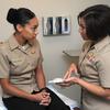 Navy Lt. Tasha Gallegos, right, talks to a patient about contraceptive care options May 18, 2018, at the Comprehensive Womens Health Center at Naval Hospital Pensacola, Fla. While briefing resources and availability of walk-in clinics for contraception counseling have increased across the Defense Department, a recent study found significant barriers continue to exist for service women's health care and family planning.
