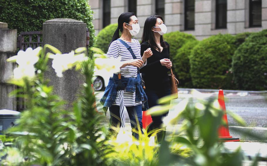 Women wear masks while out and about in Yokohama, Japan, May 24, 2021. 