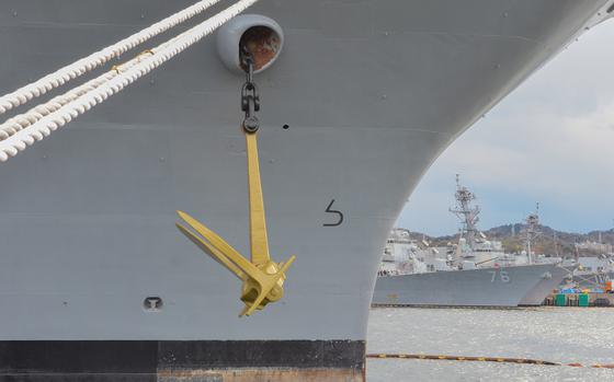 A newly painted gold anchor hangs from aircraft carrier USS Ronald Reagan at Yokosuka Naval Base, Japan, March 20, 2024. 