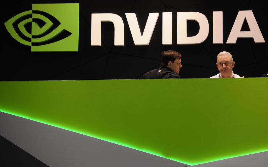 People gather in the Nvidia booth at the Mobile World Congress mobile phone trade show Thursday, Feb. 27, 2014 in Barcelona, Spain. The Federal Trade Commission on Thursday, Dec. 2, 2021 sued to block graphics chip maker Nvidia’s $40 billion purchase of chip designer Arm, saying the deal would create a powerful company that could hurt the growth of new technologies.  (AP Photo/Manu Fernandez, File)