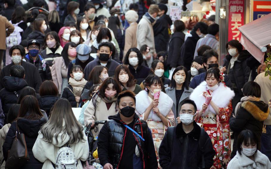 People make their way through Harajuku, Tokyo, on Coming of Age Day, Monday, Jan. 10, 2022. 
