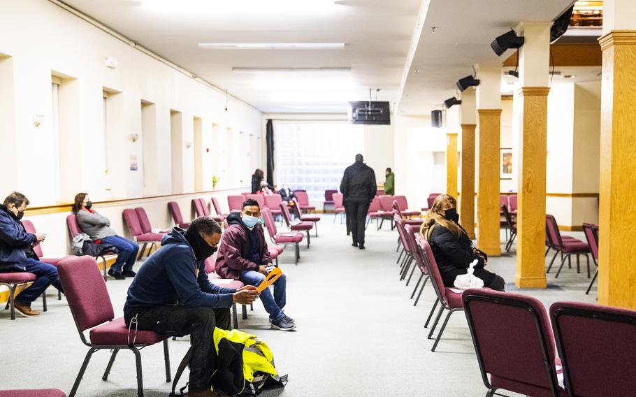 People sit in an observation area after receiving the Moderna coronavirus vaccine at an immunization event organized by the Association of Latino Professionals for America held at the Leon de Juda evangelical church in Boston on March 18, 2021. 