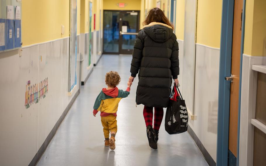A parent escorts her son to his classroom at the Lakehurst Child Development Center on Joint Base McGuire-Dix-Lakehurst, N.J., March 18, 2024.