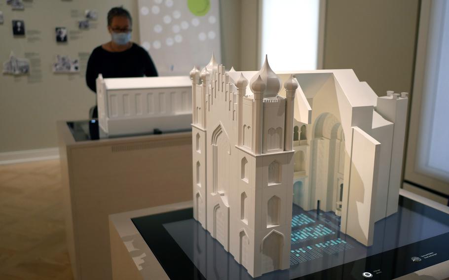 A cutout view of Frankfurt’s Main Synagogue at the Jewish Museum in Frankfurt. In the background, a visitor looks at a model of the synagogue of the Israelite Religious Society. Both were destroyed by the Nazis.