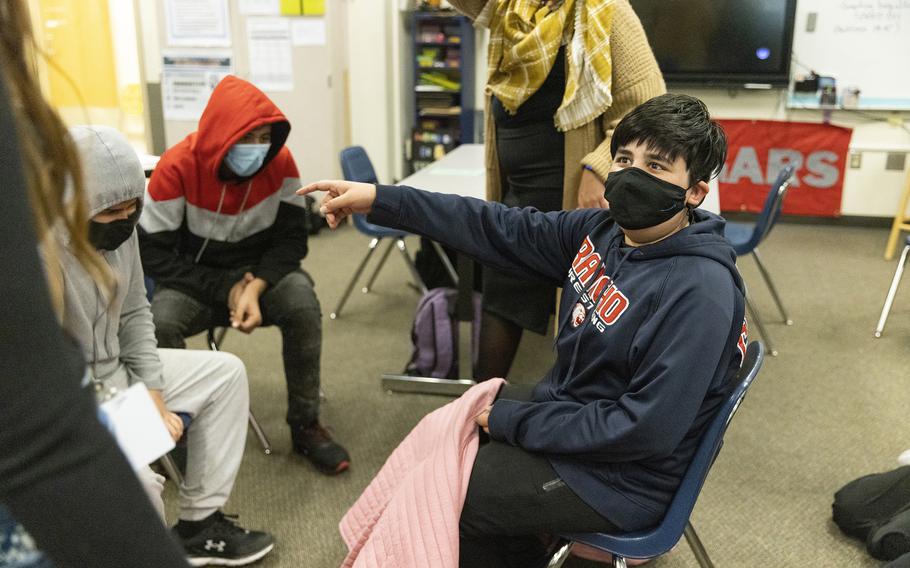 Abdullah plays a game with students at the after-school program for refugee children, run by the resettlement agency World Relief, at Mill Creek Middle School in Kent, Washington, on Tuesday, Feb. 15, 2022. 