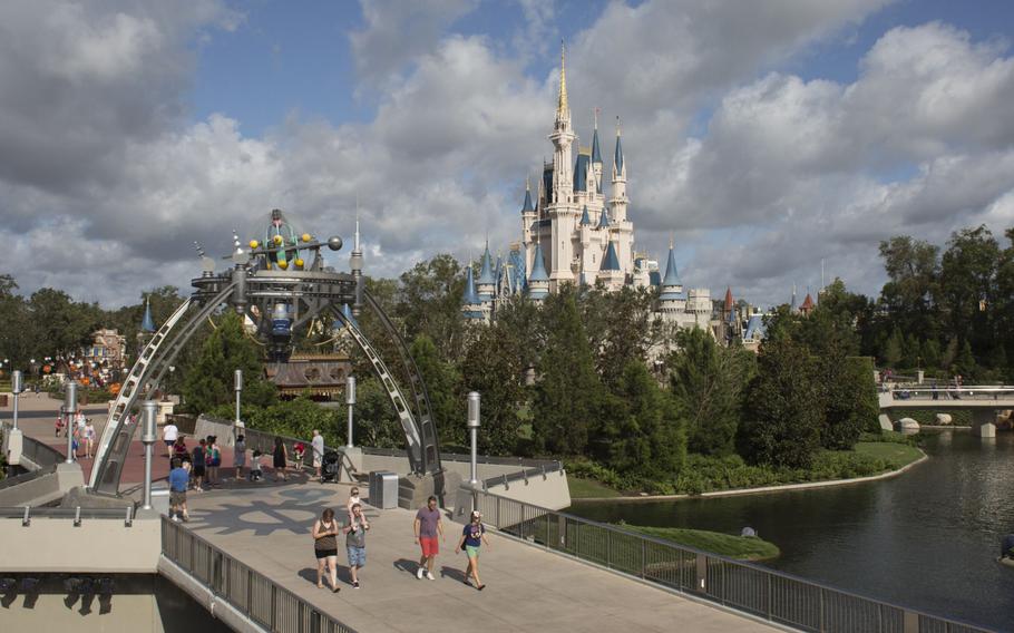 Visitors walk through the Walt Disney Co. Magic Kingdom park in Orlando on Sept. 12, 2017. 