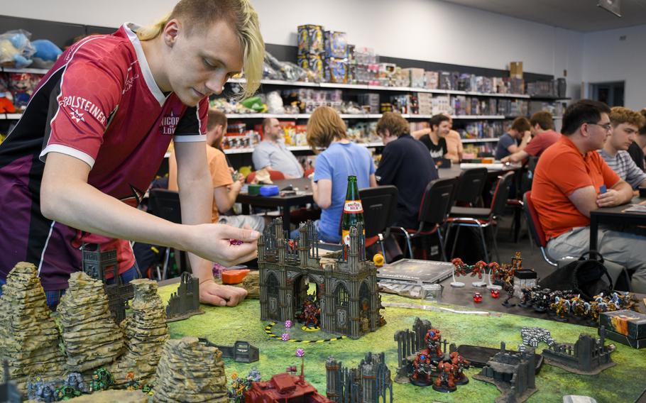Players gather each night at Battle Bear in Kaiserslautern to play trading card games and sometimes the tabletop game Warhammer 40,000 with other fans.
