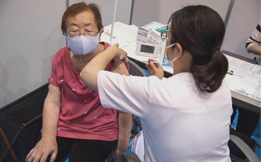 A woman is inoculated at a COVID-19 vaccination center in Yokohama, Japan, Monday, May 17, 2021.