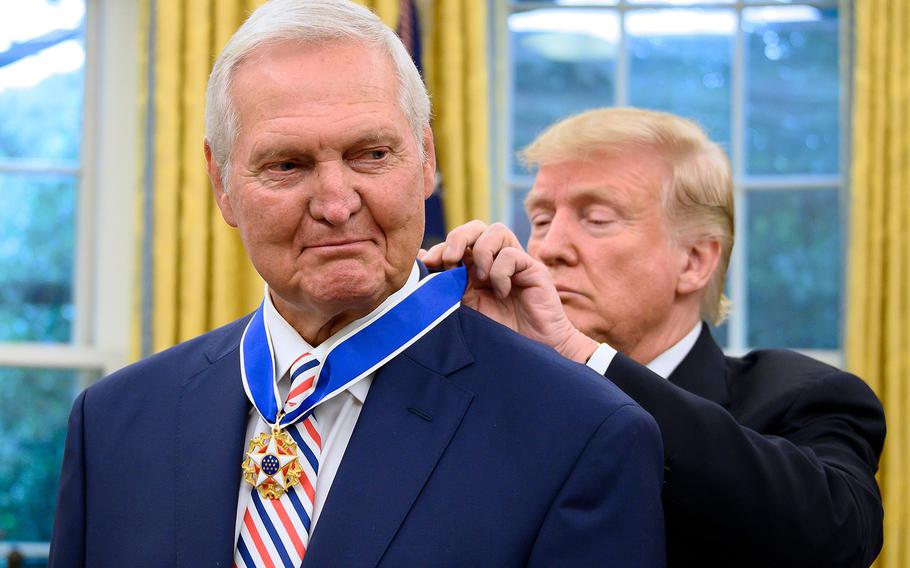 President Donald Trump presents the Presidential Medal of Freedom to Los Angeles Lakers basketball legend Jerry West in the Oval Office of the White House in Washington on Sept. 5, 2019. 