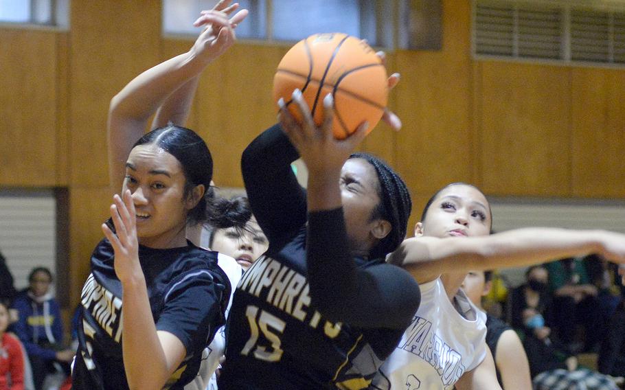 Humphreys' Sabra Wrightsil comes down with a rebound against St. Paul Christian during Friday's 5th American School In Japan Kanto Classic girls knockout game. The Warriors won 38-26.