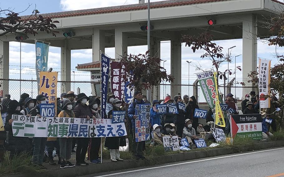 Protesters gather outside Camp Schwab, Okinawa, Friday, Jan. 12, 2024, following the restart of construction for a runway being built into Oura Bay.