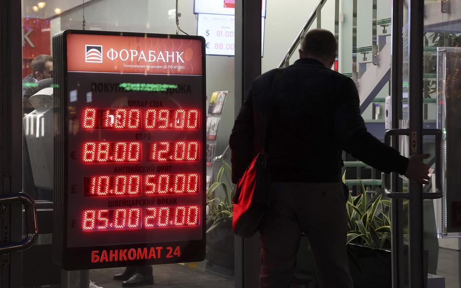 Foreign currency exchange rates at a bank in Moscow, Russia, on Feb. 28, 2022. Sanctions pushed the ruble to a record low. 