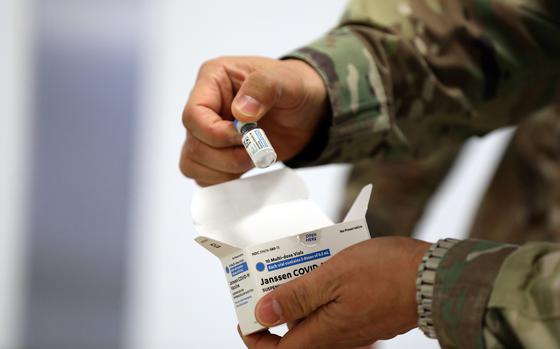 Vials of Johnson & Johnson's Janssen COVID-19 vaccine are checked upon arrival at Camp Humphreys, South Korea, March 9, 2021. 