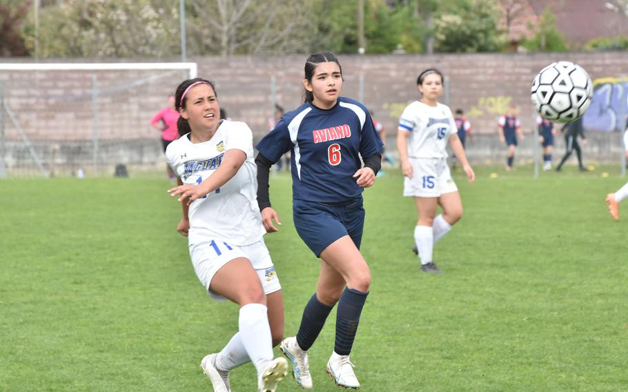 Sigonella's Leila Denton and Aviano's Mia Davila watch Denton's attempt on goal in the Jaguars' 4-1 victory over the Saints on Saturday, April 15, 2023.