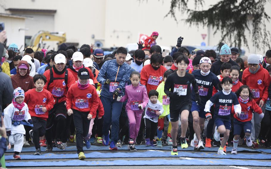 People participate in a 2-kilometer family run during the 42nd annual Yokota Striders Frostbite Road Race at Yokota Air Base, Japan, Sunday, Jan. 22, 2023.