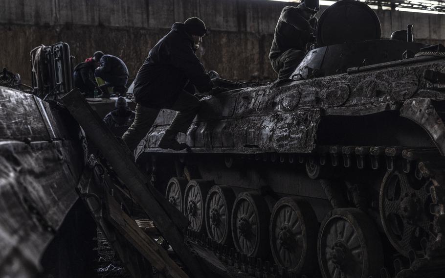 Members of the maintenance battalion for the 14th Separate Mechanized Brigade at work at their field repair site. 