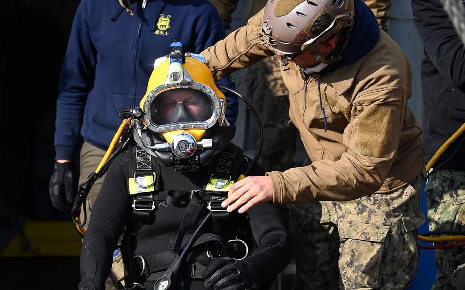 A U.S. Navy diver takes part in recovery efforts on Dec. 25, 2023, after a CV-22 Osprey crash the previous month killed eight crewmembers.
