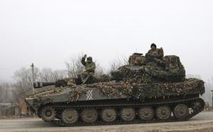In this image made from a video, Russian soldiers ride on a self-propelled gun in Russia’s Kursk region.