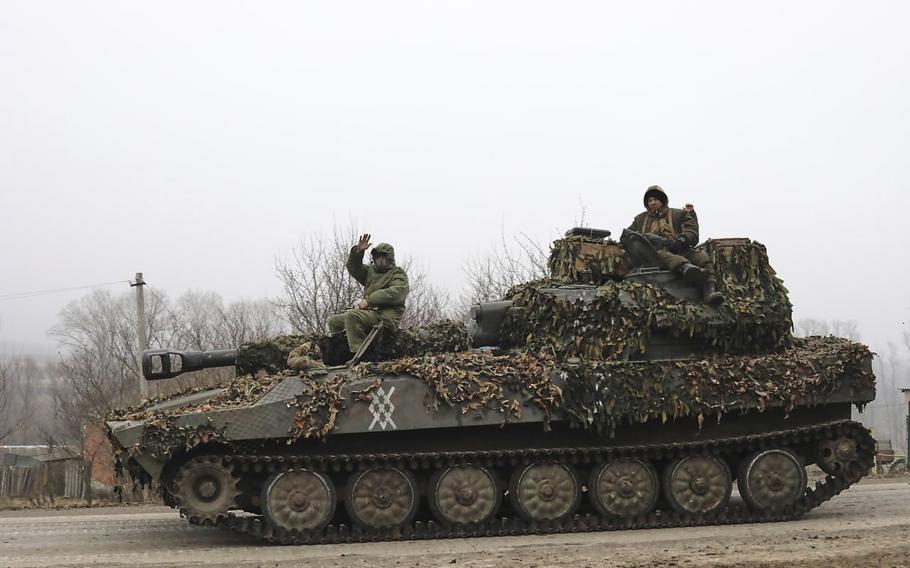 In this image made from a video, Russian soldiers ride on a self-propelled gun in Russia’s Kursk region.
